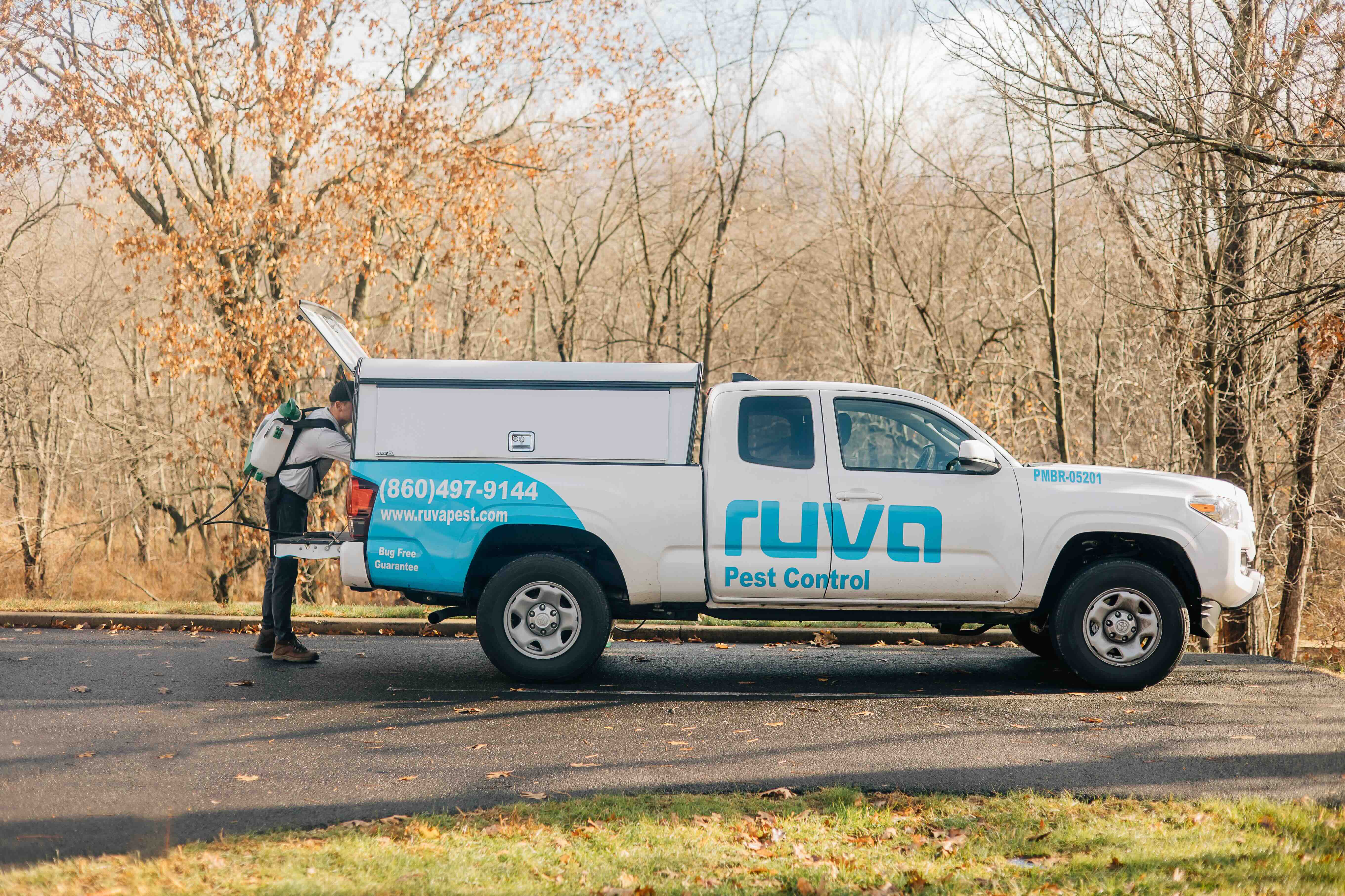 Ruva Pest Control technician with service truck in Hartford, CT