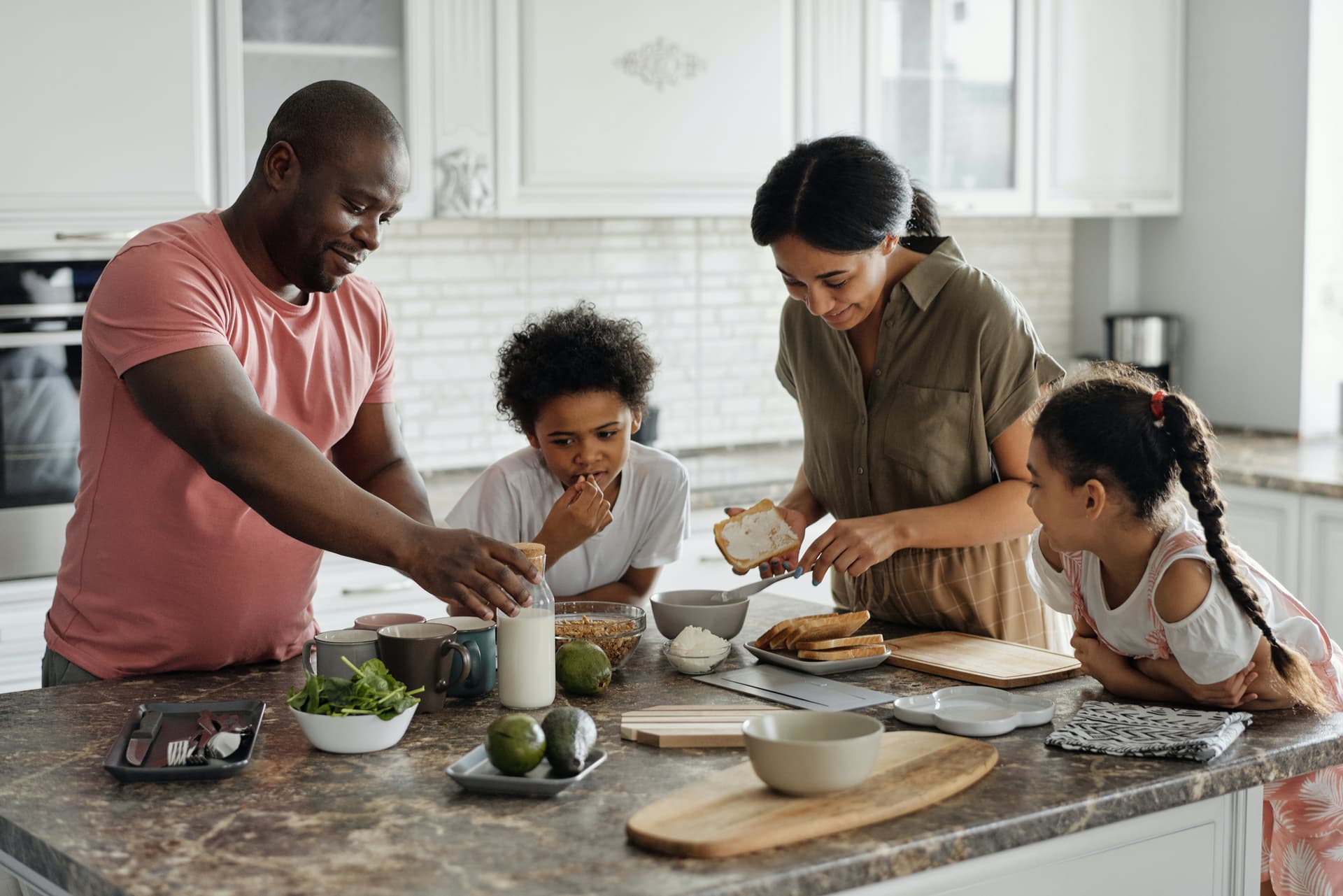 Happy family preparing food together in their pest-free kitchen